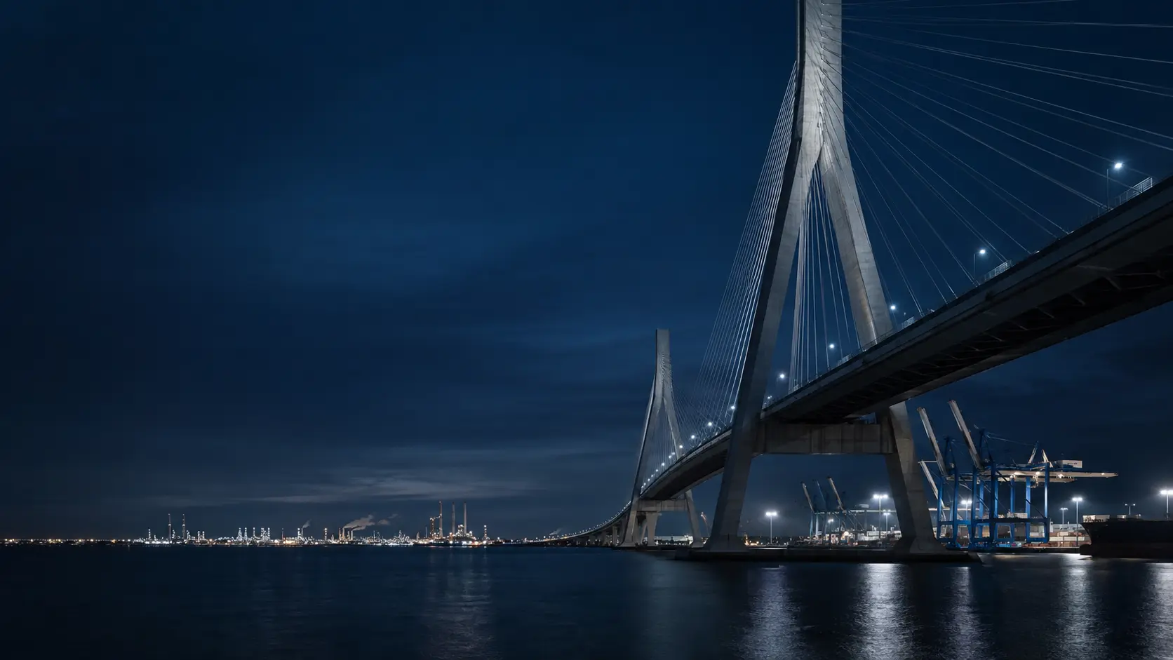 Cable-stayed bridge and international port infrastructure at blue hour
